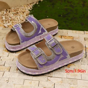 Macro shot of purple rhinestone platform sandals featuring 5cm cork wedge heel details.
