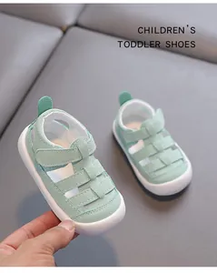 Close-up of mint green hollow out toddler sandals with protective closed toe and soft sole