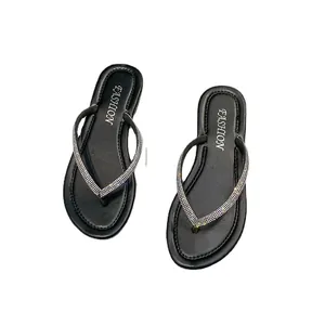 Stylish women's black flip-flops featuring shimmering rhinestone straps and FASHION logo