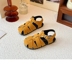Detailed view of yellow woven retro Roman sandals for children with closed-toe design.