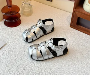 Detailed view of silver children's Roman woven sandals with secure buckle and closed toe