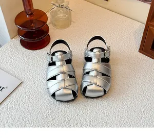 Close-up detail showing the metallic silver woven straps of these retro children gladiator sandals