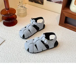 Close-up of children's retro woven Roman sandals with light blue closed-toe design