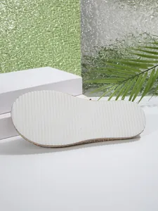 Detailed view of the anti-slip textured white sole on women's flat summer slippers
