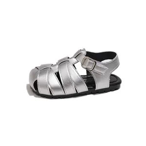 Silver metallic children's woven Roman sandals with closed-toe design for summer.