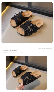 Close-up of kids' black sandals showing cork-bed details and adjustable metal buckles