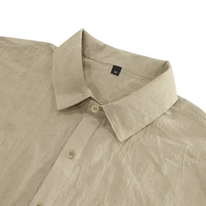 Detail view of a men's khaki linen shirt showing the lapel collar and fabric texture.