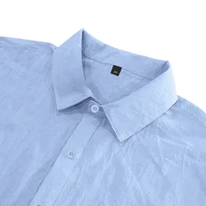 Close-up view of light blue linen shirt collar showing fabric texture and buttons.