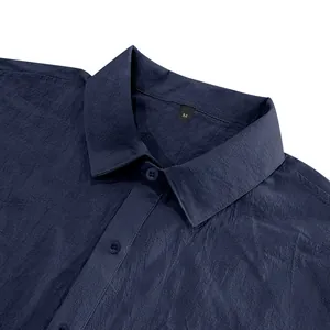 Detailed close-up view of a men's navy blue linen shirt collar showing fabric texture.