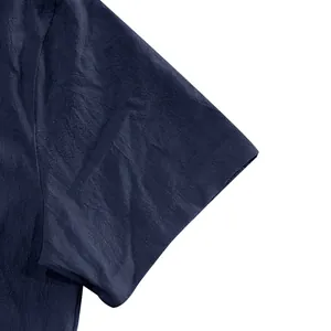 Close-up of the breathable navy blue linen fabric on a men's short sleeve casual shirt