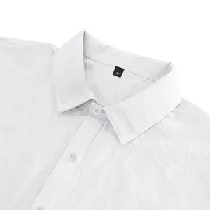 Detail shot of a white linen shirt collar showing premium fabric texture and size tag