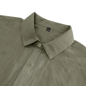 Macro detail of olive green men's linen shirt collar with size M label and buttons