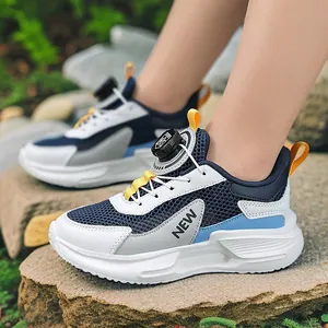 Breathable boys mesh sports running shoes with rotating dial lace on outdoor rocks