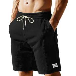 Close-up detail of men's black corduroy casual shorts with functional drawstring waist