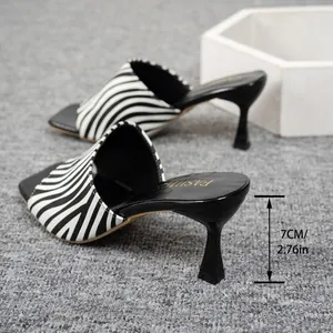 Macro detail view showing the 7cm slim heel on these zebra-striped women's mules