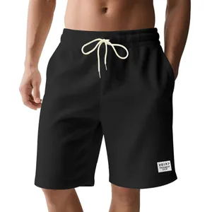 Detail view of men's black corduroy shorts with adjustable drawstring and rib texture
