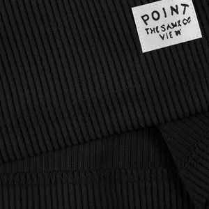 Close-up of black ribbed corduroy fabric and 'POINT' woven label on men's shorts