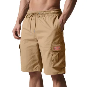 Detailed view of khaki men's cargo shorts with elastic drawstring waist and side pockets
