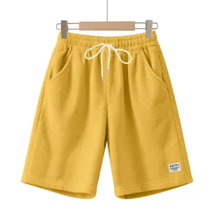 Macro view showing the corduroy texture and drawstring of these men's yellow casual shorts