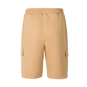 Detailed view of khaki men's cargo shorts featuring elastic waistband and flap pockets