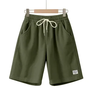 Close-up detail of olive green men's corduroy shorts featuring adjustable white drawstring