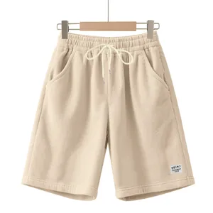 Close-up detail of men's beige corduroy drawstring shorts showing texture and tie