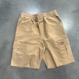 Full view of men's khaki cargo shorts featuring elastic waist and utility pockets