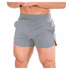 Professional close-up of men's gray quick-dry athletic shorts with split side hem details
