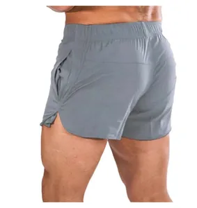 Back view detail of men's grey quick-dry sports shorts on a fitness model in studio