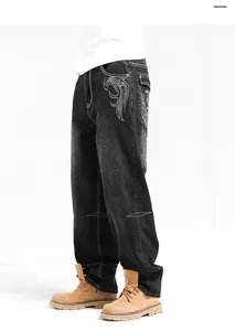 Oversized black denim jeans featuring unique embroidery and contrast stitching for tall men