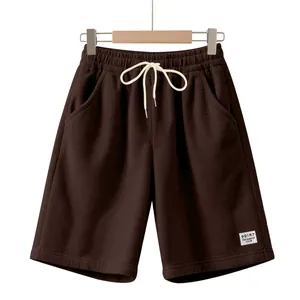 Close-up of men's brown corduroy shorts featuring a drawstring waist and side pockets