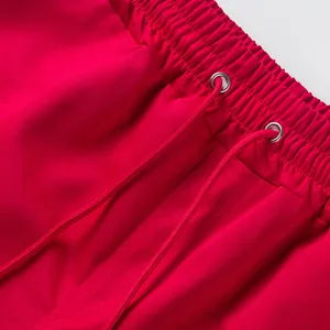 Close-up detail of red high street shorts showing elastic waistband and drawstring