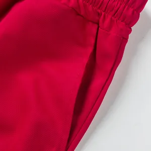 Close-up detail of red men's casual cargo shorts featuring elastic waist and pocket