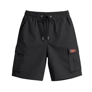 Detail of men's black cargo shorts with elastic drawstring waist and side flap pockets