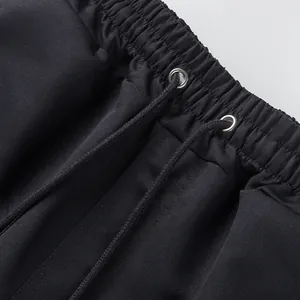 Detailed macro shot of elastic waistband and drawstring on black casual cargo shorts