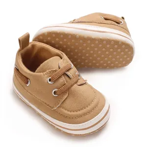 Macro view showing the canvas texture and soft polka dot sole of the baby shoes