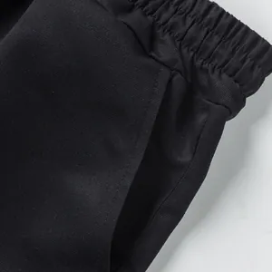 Close-up of elastic waistband and pocket on men's black cargo shorts
