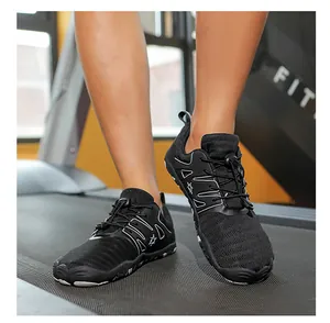 Detail view of black breathable barefoot athletic sneakers on a gym treadmill for fitness