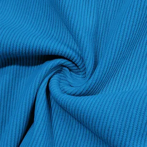 Macro view showing the soft rib texture of premium blue corduroy fabric material