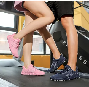 Couple wearing breathable non-slip sports shoes while training on a treadmill in a gym