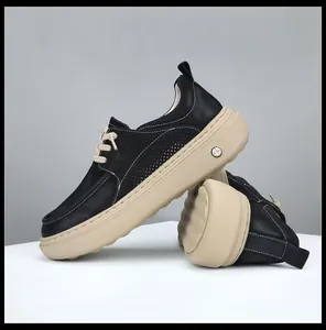 Detailed side view of trendy black leather platform loafers with chunky beige rubber soles