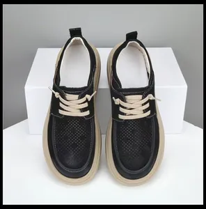 Detail view of men's black cowhide leather loafers with unique skewed toe design.