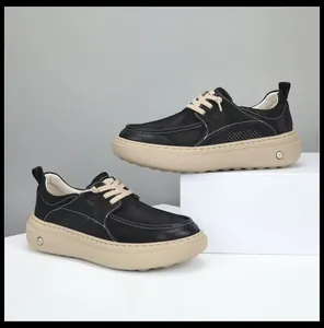 Stylish men's black leather loafers with a thick beige platform sole and contrast laces.