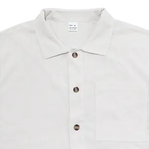 Close-up detail of a men's light grey corduroy shirt showing the collar and ribbed fabric texture