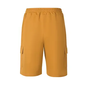 Detail view of mustard yellow men's cargo shorts with elastic waist and side pockets