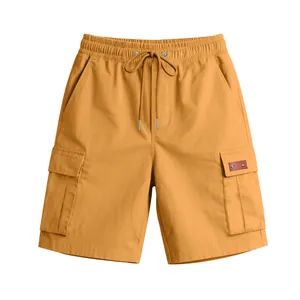 Detailed view of ochre cargo shorts featuring elastic drawstring waist and side pockets