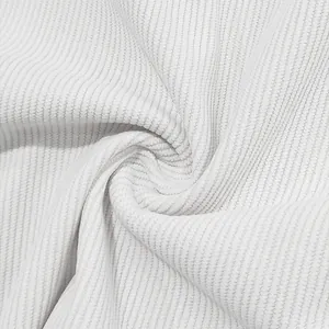 Macro detail shot showing the soft ribbed texture of white corduroy fabric for men's sets.