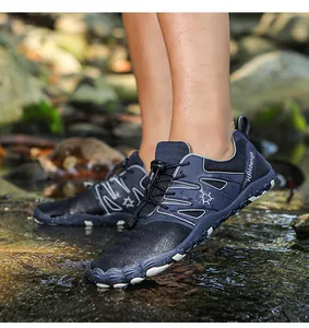 Non-slip breathable outdoor water shoes worn in a shallow forest stream environment