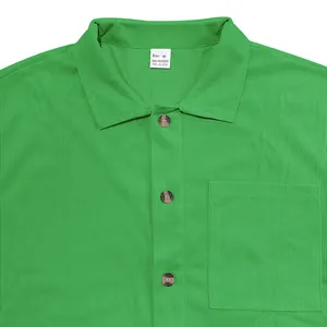 Detail of green corduroy shirt showing ribbed texture, pocket and button closure