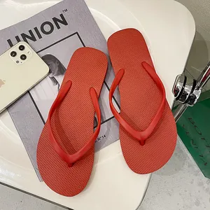 Detailed view of bright red non-slip flip-flops featuring a stylish minimalist strap design